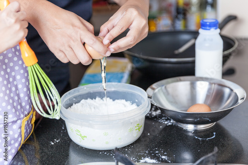 Little asian girl making pancake