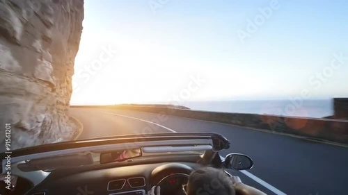 Couple driving convertible car cabriolet cape town south africa steadicam shot