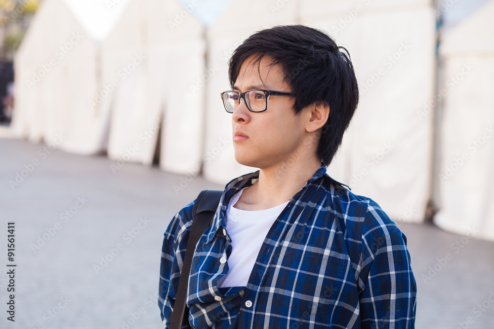Asian man with glasses stand at street, closeup portrait. Asian man with glasses stand at street, closeup portrait.