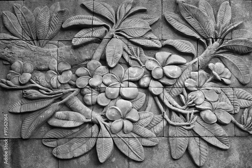 Black and white of low relief cement Thai style handcraft of plu photo