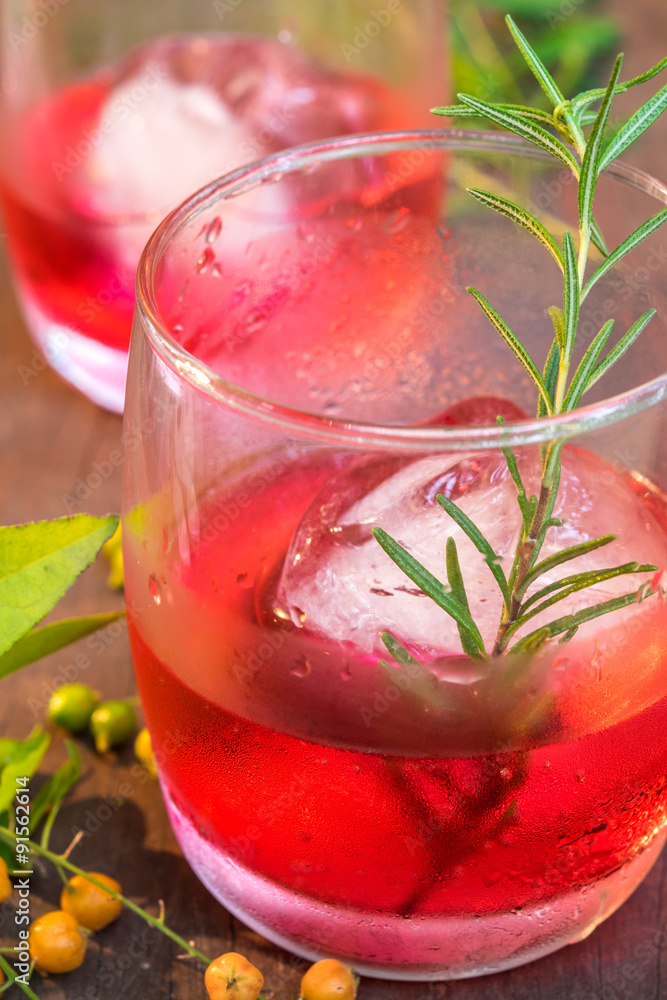 Glasses of refreshment raspberry flavor fizz with ice and rosema Glasses of refreshment raspberry flavor fizz with ice and rosema