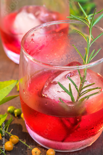 Glasses of refreshment raspberry flavor fizz with ice and rosema