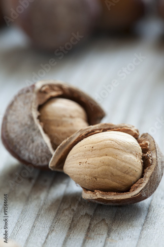 Hazelnuts on old wooden background