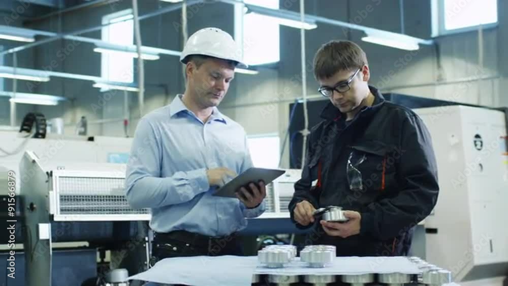 Engineer in Hard Hat and Factory Worker are Inspecting Quality of Detail on Factory Engineer in Hard Hat and Factory Worker are Inspecting Quality of Detail on Factory