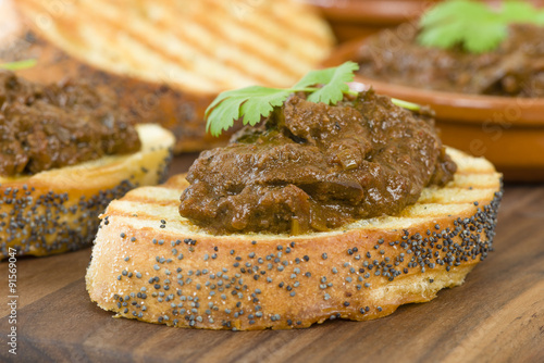 Higados de Pollo - Chicken livers with chorizo & spring onions finished with a dark Cajun tomato sauce on top of crusty bread.
 photo