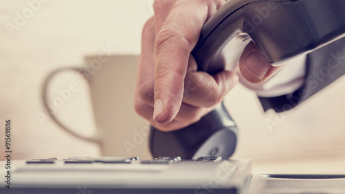 Wallpaper Mural Retro image of male hand dialing a telephone number Torontodigital.ca