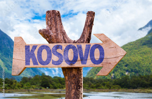 Kosovo wooden sign with mountains on background photo