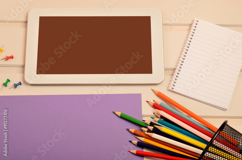 Tablet with paper and colorful pencil
