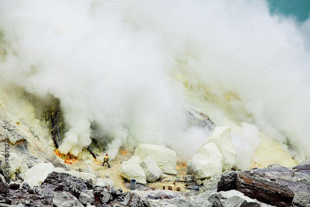 Worker extract the sulfur from active volcano