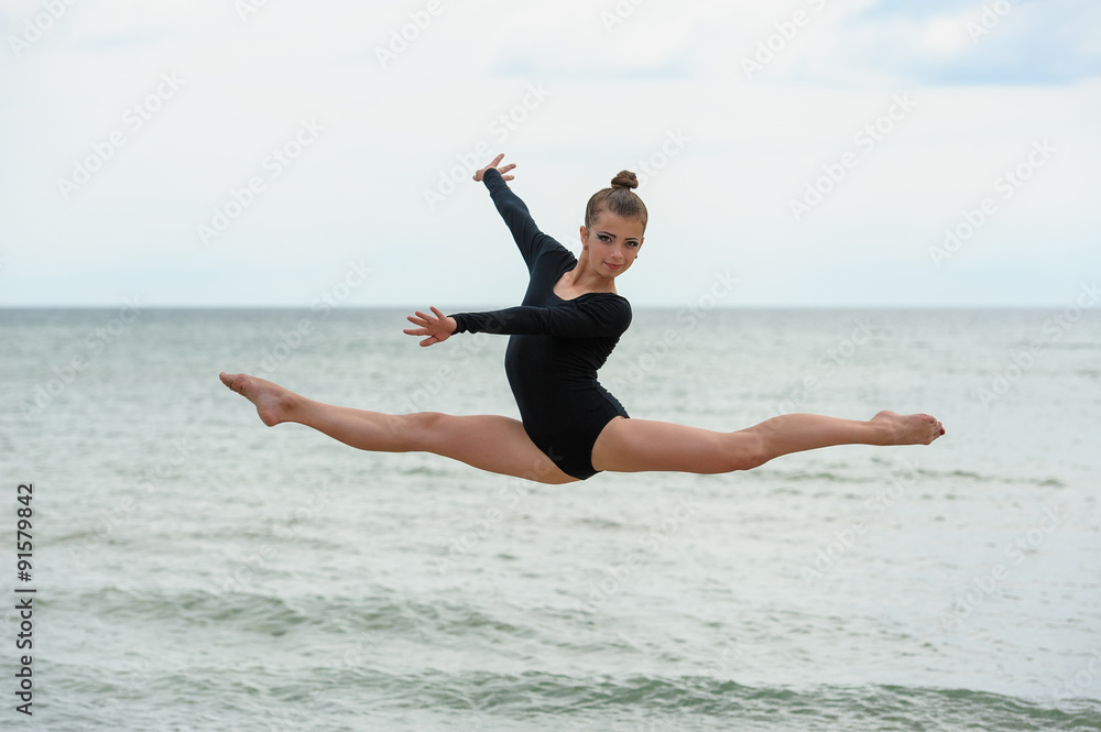 Gymnast Dancer Jumping On The Sea Beach