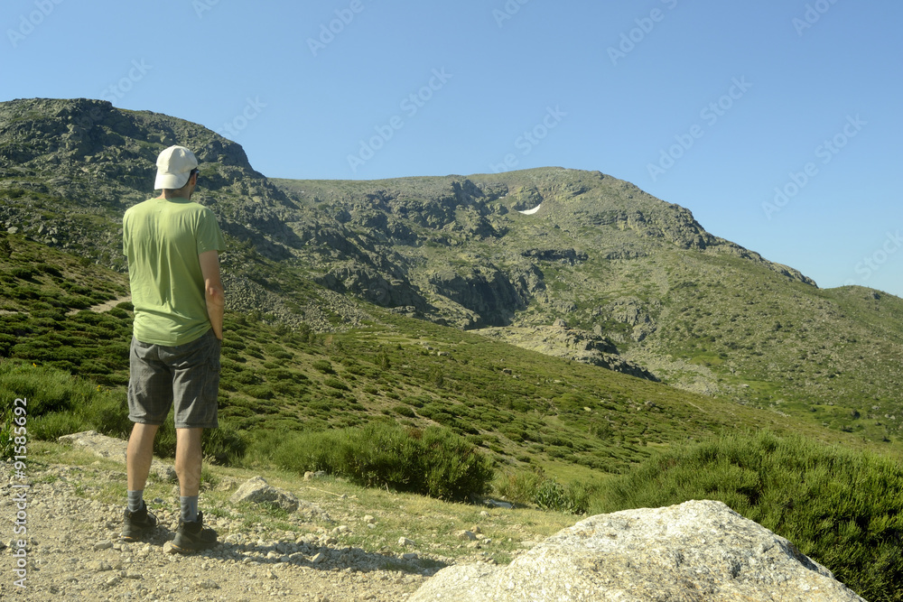 Young man in the mountain, from backside