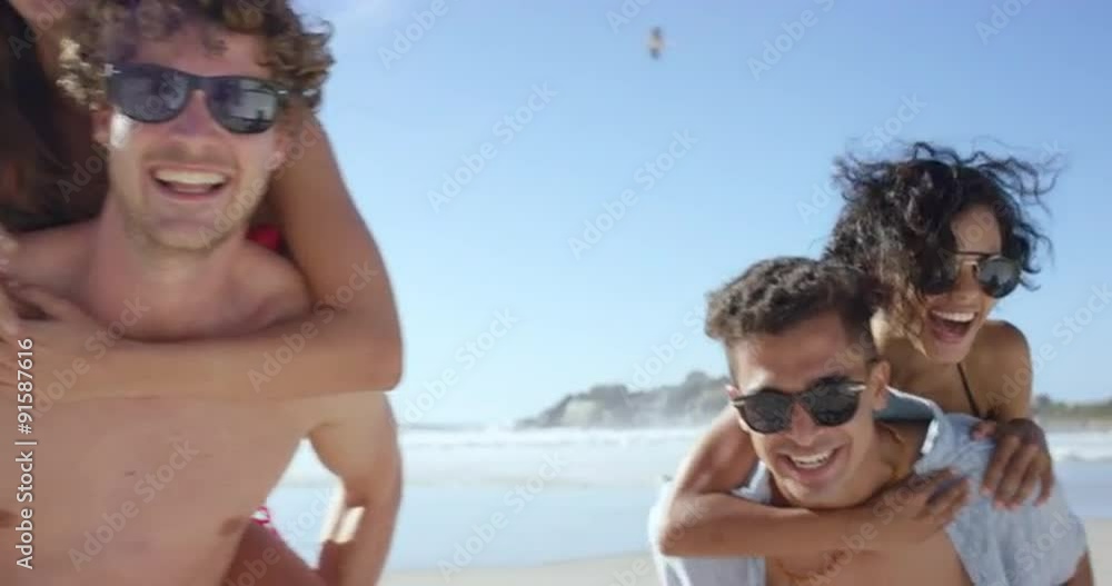 Beach couples giving piggybacks laughing having fun on vacation Beach couples giving piggybacks laughing having fun on vacation