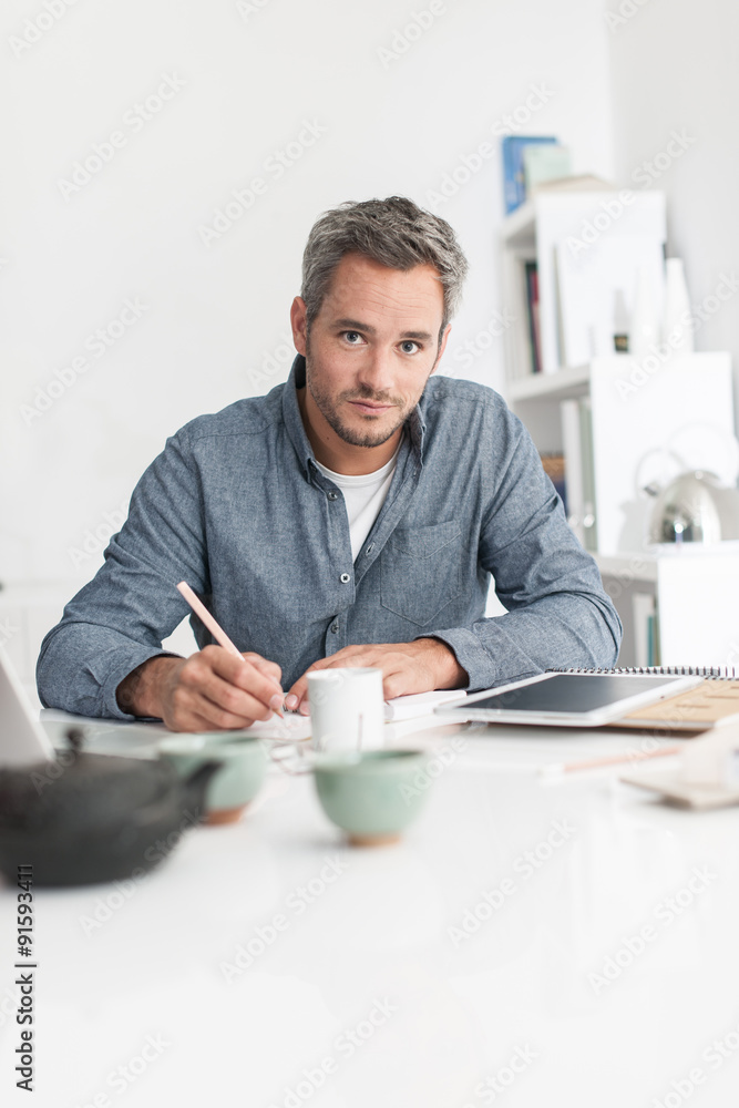 Portrait of a nice grey hair man with beard, working at home on Portrait of a nice grey hair man with beard, working at home on