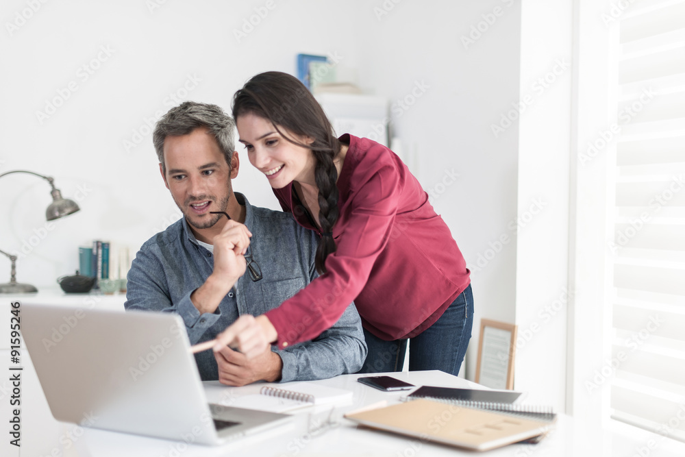 Portrait of a smiling couple planning their next trip, the grey Portrait of a smiling couple planning their next trip, the grey