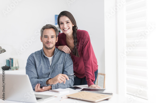 Portrait of a smiling couple working home, the grey hair man wit © jackfrog