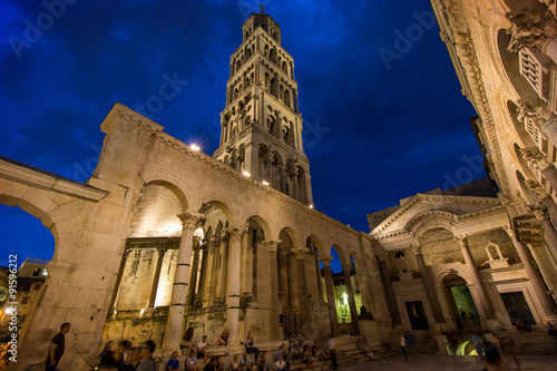 Принти на полотні People at the Diocletian's Palace's peristyle in front of Cathedral of Saint Domnius' bell tower in Split, Croatia at evening
