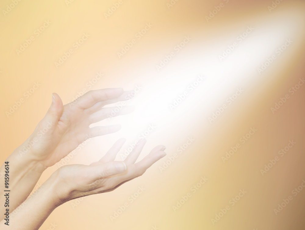 Beautiful Golden Healing Energy - Female healing hands outstretched with  bright shaft of light beaming out and up on a pale golden background Stock  Photo