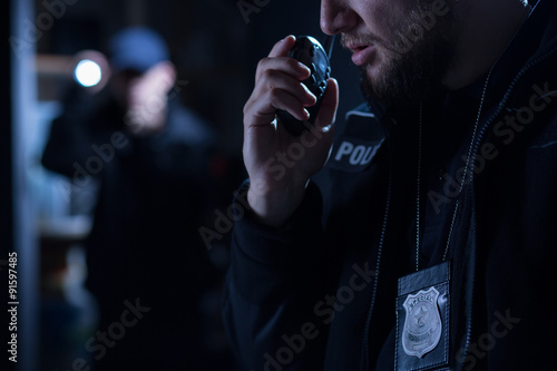 Officer using walkie talkie photo