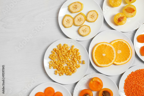 Set of orange products on wooden background