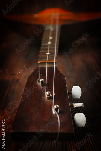 Folk musical instrument balalaika on wooden background