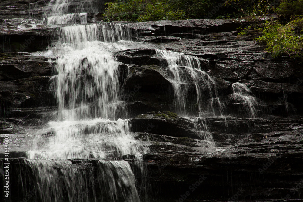 Mountain waterfall tumbling over rocks Mountain waterfall tumbling over rocks