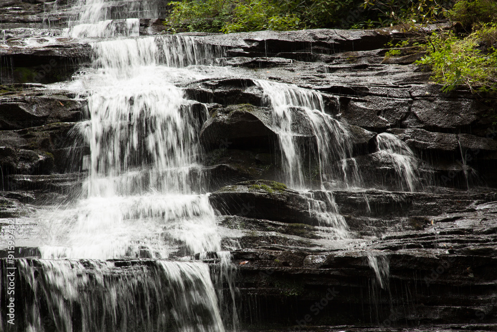 Fototapeta premium Mountain waterfall tumbling over rocks