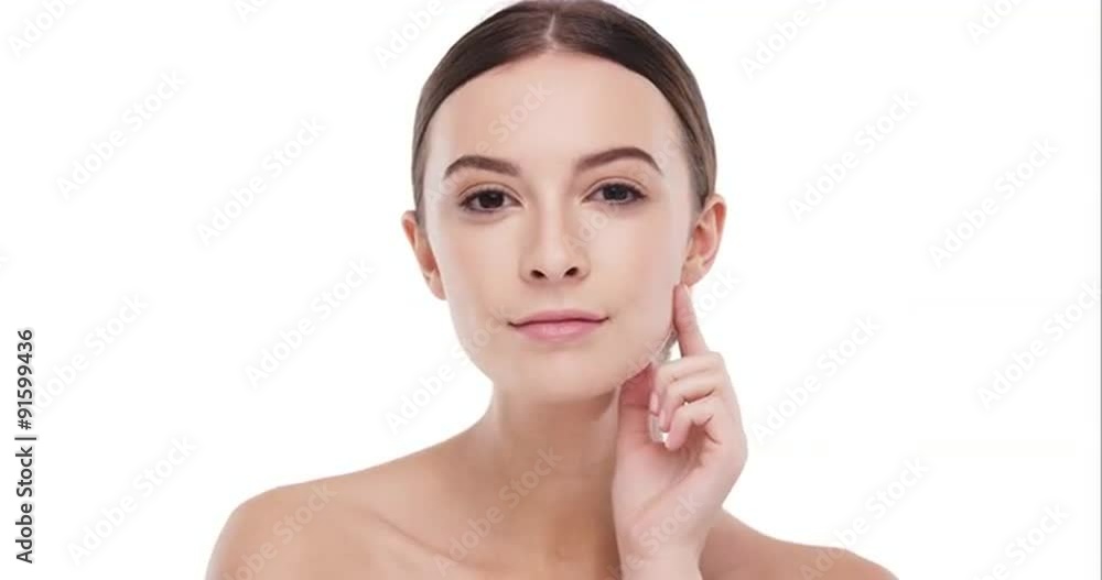 Beauty portrait of woman touching beautiful face in slow motion skincare concept on a white background Beauty portrait of woman touching beautiful face in slow motion skincare concept on a white background