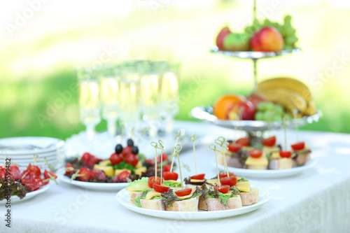 Snacks  fruits and drinks on table  outdoors. Garden party concept
