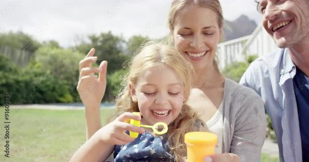 Happy family blowing bubbles in the yard at home Happy family blowing bubbles in the yard at home