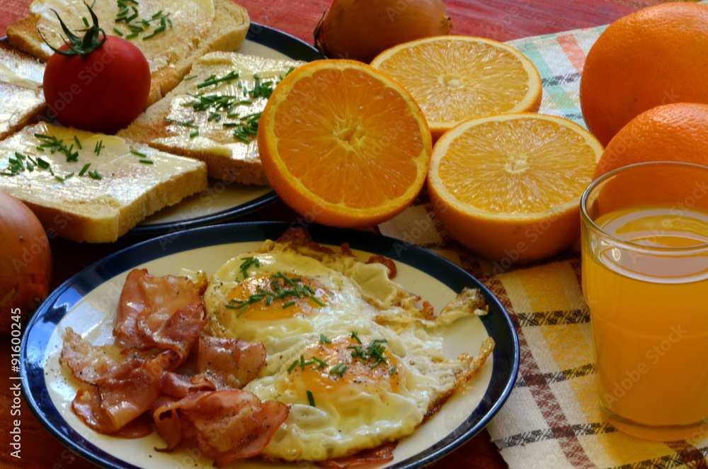 Rustic breakfast - roasted bread with butter and chives, fried eggs and bacon. Rustic breakfast - roasted bread with butter and chives, fried eggs and bacon.
