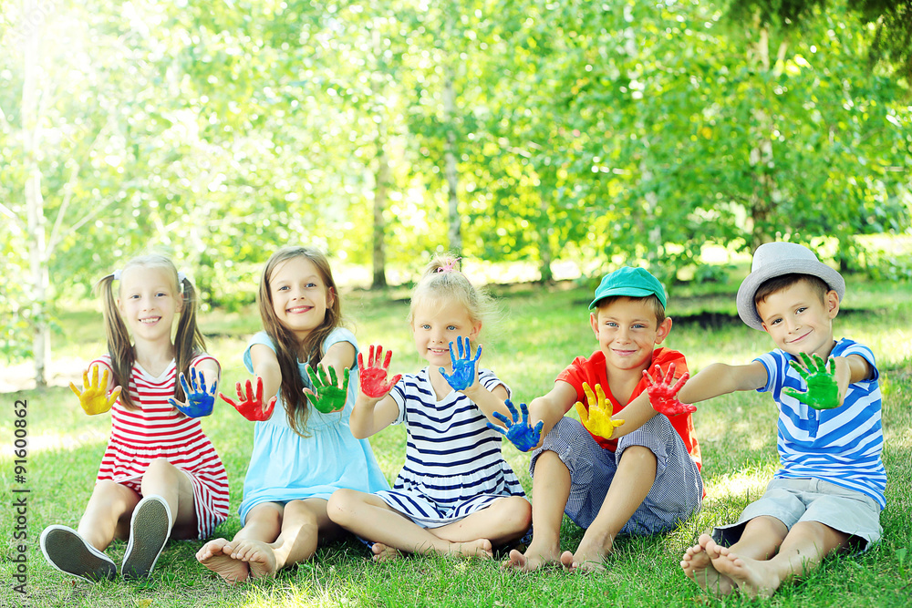 Happy active children with bright colored palms in park Happy active children with bright colored palms in park