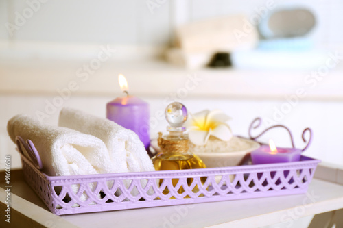 Spa stones and spa treatments on tray, on light background