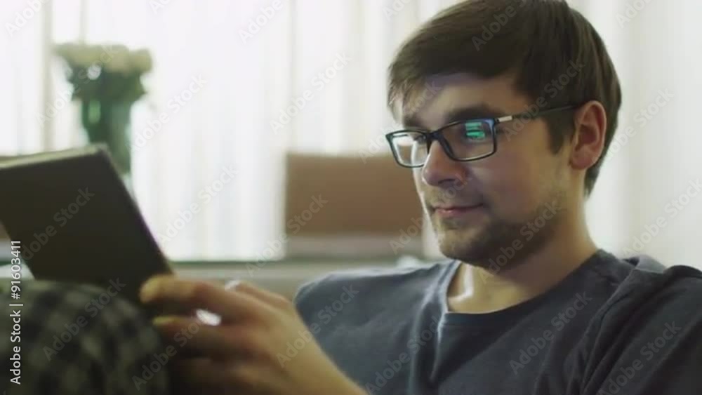 Man is Using Tablet at Morning in Home. Shot on RED Cinema Camera in 4K (UHD). Man is Using Tablet at Morning in Home. Shot on RED Cinema Camera in 4K (UHD).