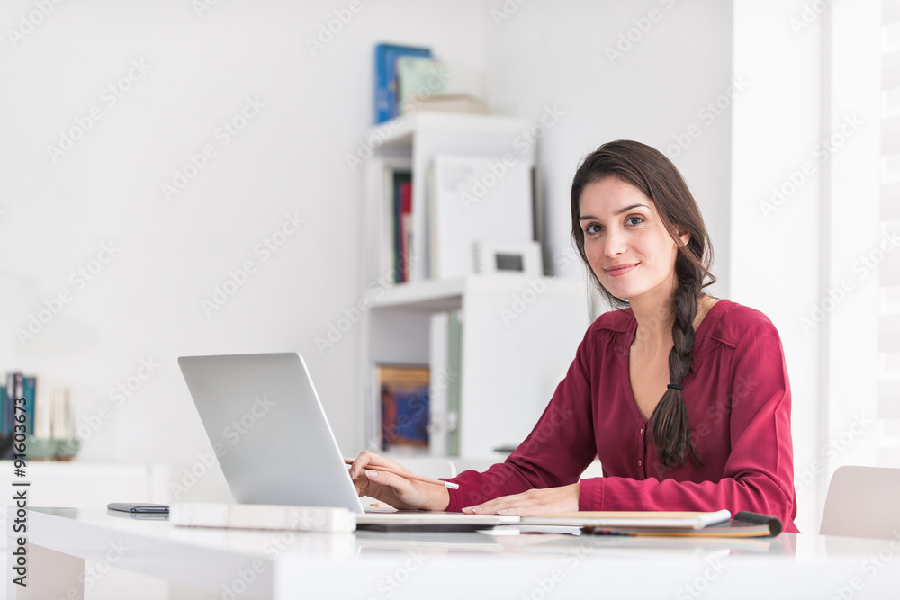 Portrait of a dark braided hair woman looking at camera while ho Portrait of a dark braided hair woman looking at camera while ho