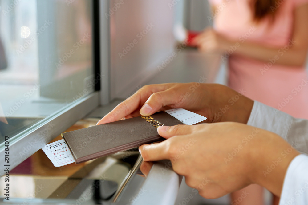 Obraz premium Woman buying tickets with passport at box office