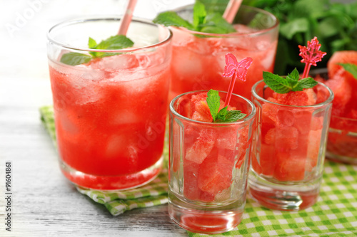 Cold watermelon desserts and drinks in glasses  on wooden table background