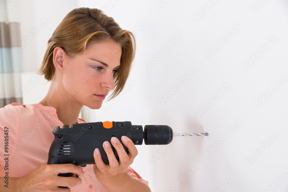 Woman Making Hole With Drill Machine Woman Making Hole With Drill Machine