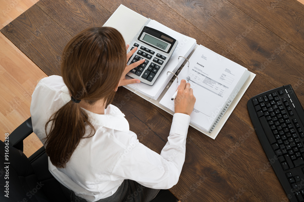 Businesswoman With Invoice And Calculator Businesswoman With Invoice And Calculator