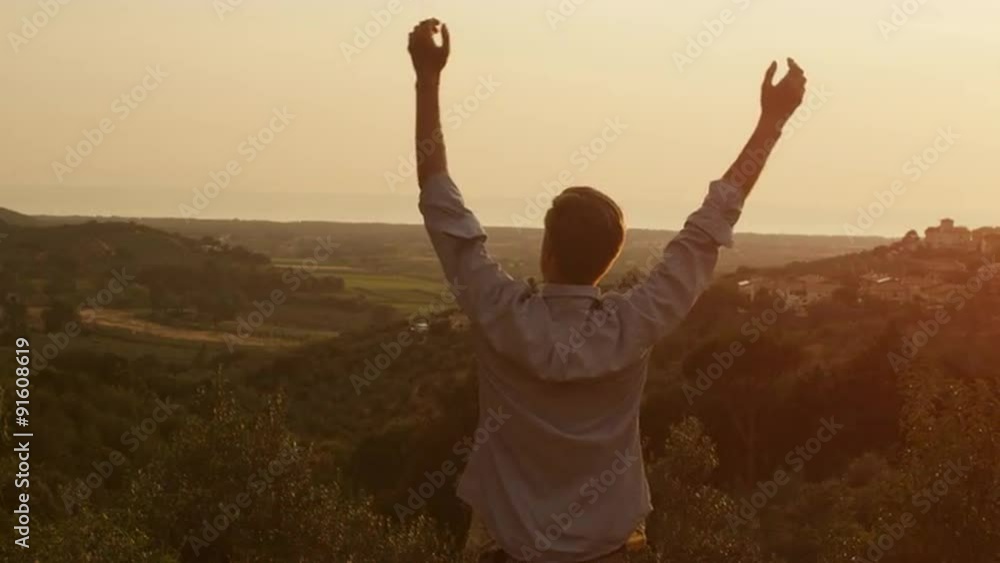 Man and Raising Hands in Sunset Light. Shot on RED Cinema Camera. Man and Raising Hands in Sunset Light. Shot on RED Cinema Camera.