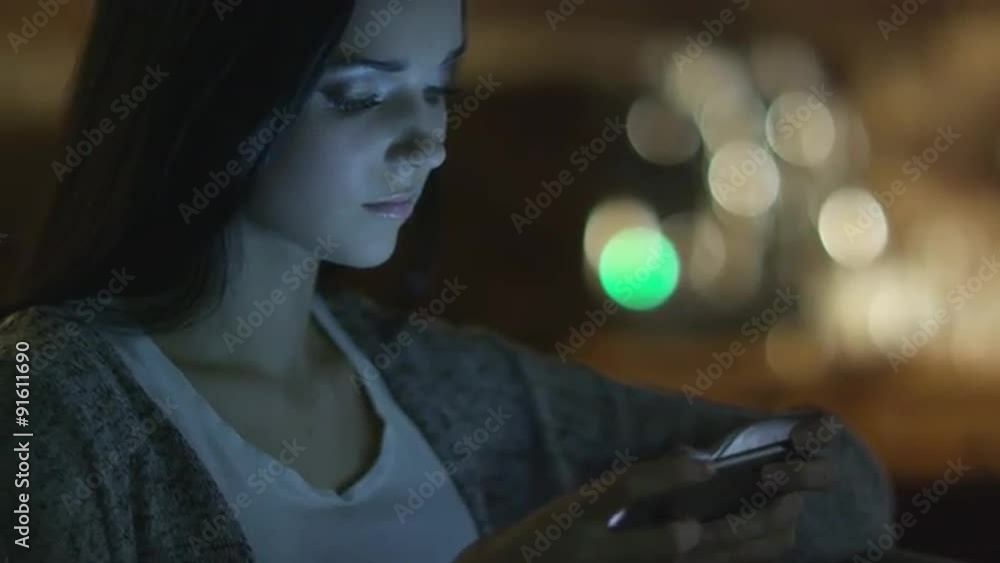 Teen Girl with Beautiful Smile is Using Smartphone at Evening. Casual Lifestyle.