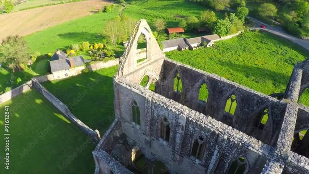 An amazing reverse reveal aerial view over the abandoned Tintern Abbey in Wales, United Kingdom. An amazing reverse reveal aerial view over the abandoned Tintern Abbey in Wales, United Kingdom.