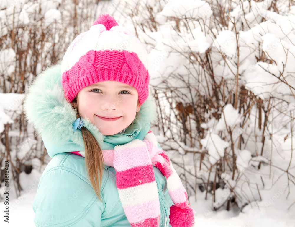 Fototapeta premium Portrait of smiling little girl in winter day