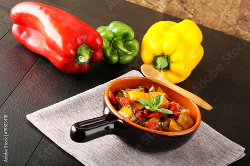 Peperonata: peppers cut into slices and baked in a pan photo