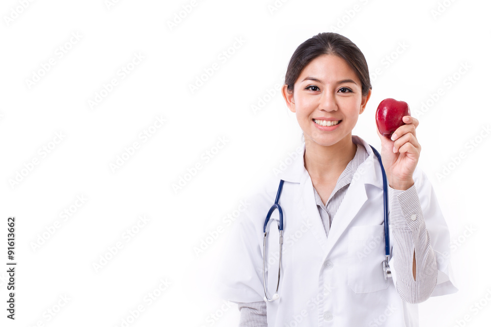 female doctor with hand holding red apple, concept of healthy fo