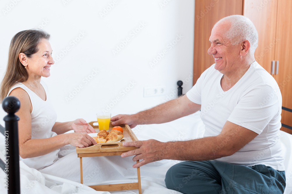 couple having breakfast in bed. couple having breakfast in bed.