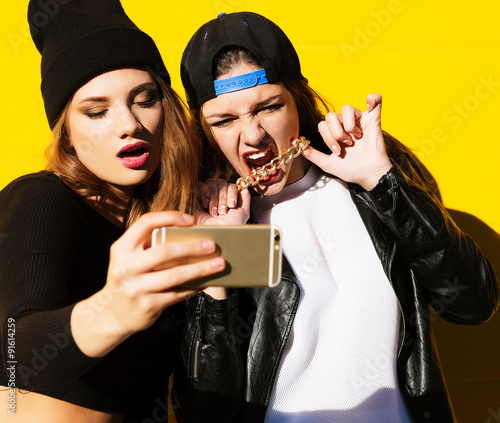 teenage girls friends outdoors make selfie on a phone. 