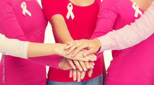 close up of women with cancer awareness ribbons © Syda Productions