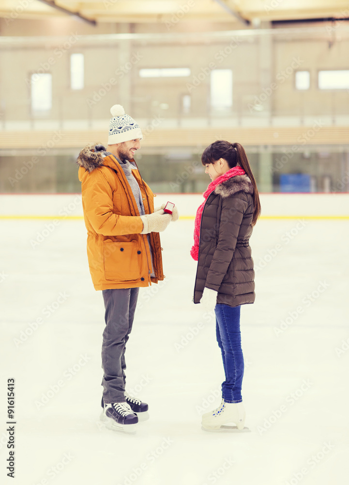 happy couple with engagement ring on skating rink happy couple with engagement ring on skating rink
