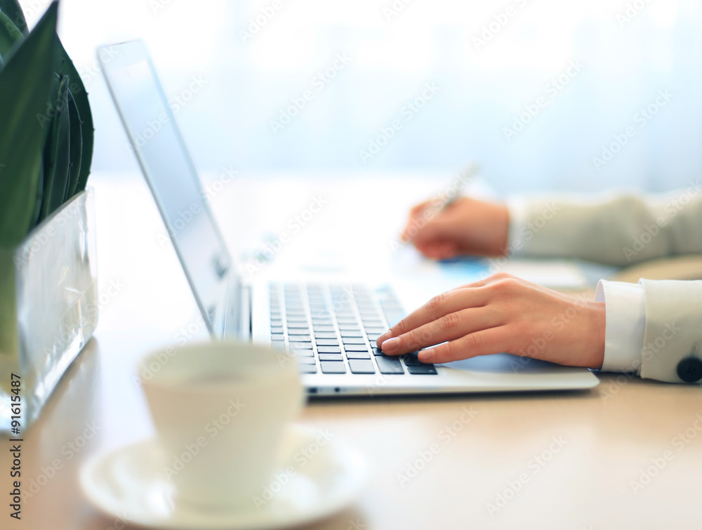 Hands of an executive working on his laptop at the office Hands of an executive working on his laptop at the office