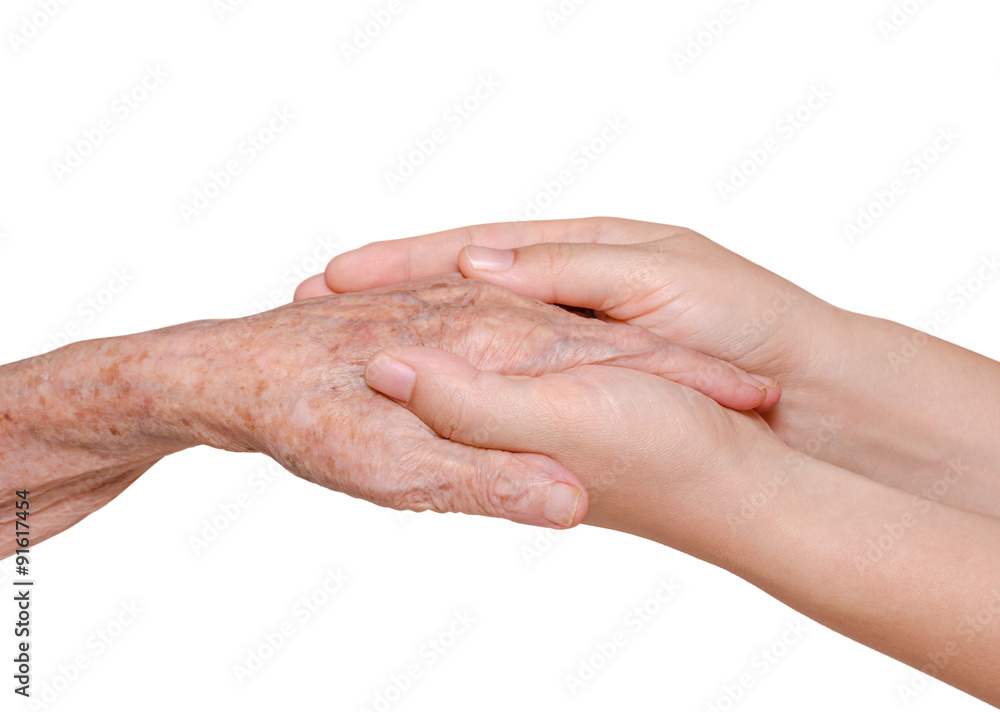 Young woman holding her grandmother hand over white background Young woman holding her grandmother hand over white background